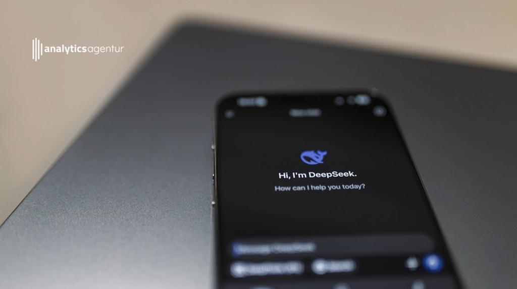 Smartphone mit schwarzem Bildschirm, das die DeepSeek-Anwendung zeigt, die nach Hilfe fragt.